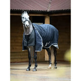 Navy blue quilted lemieux anti rub bib with silver zippers and white trim featuring wither guard for horses