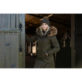 Woman in dark green Lemieux Anya Waterproof Riding Coat Alpine with fur-trimmed hood