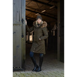 Woman in Lemieux Anya Waterproof Riding Coat Alpine with fur-trimmed hood and black boots