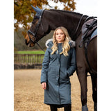 Dark brown horse with rider in blue coat showcasing Lemieux Anya Waterproof Riding Coat Petrol