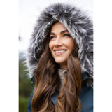 Woman smiling in Lemieux Anya Waterproof Riding Coat Petrol with fur-trimmed hood