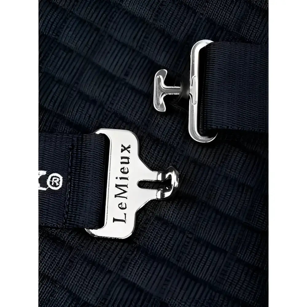 Silver-toned metal buckle with lemieux engraved on black strap of lemieux arika clima-tek rich navy rug with moisture control