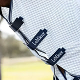 Lemieux arika field checkered horse rug in white and black with navy trim and lemieux labels field rug white
