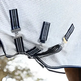 White and navy checkered lemieux arika field rug with black and white striped straps and silver buckles field rug white