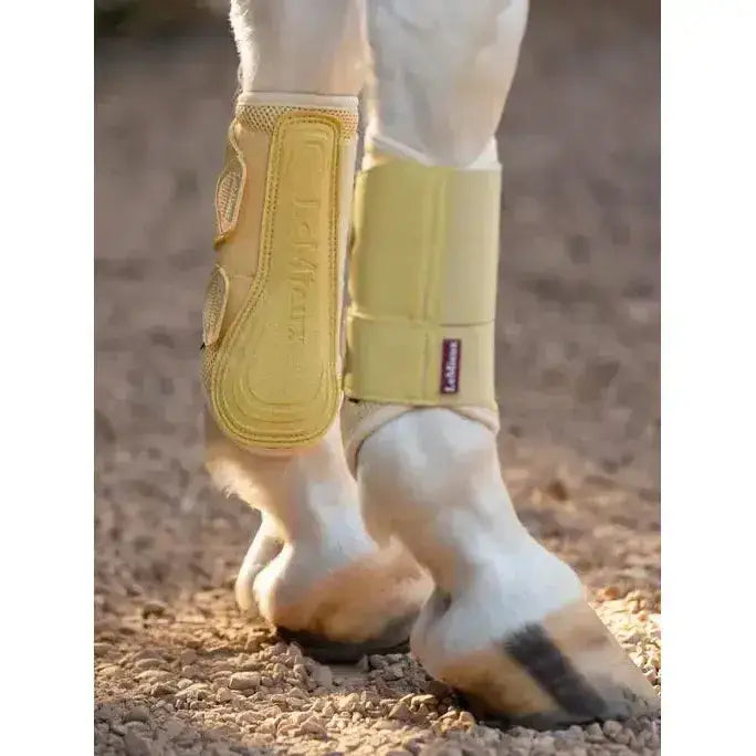 Yellow lemieux arika mesh brushing boots mimosa with padded mesh design and adjustable straps for horse leg protection