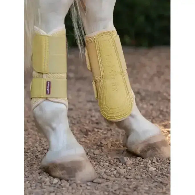 Yellow lemieux arika mesh brushing boots mimosa with padded mesh and equine brand label for leg protection