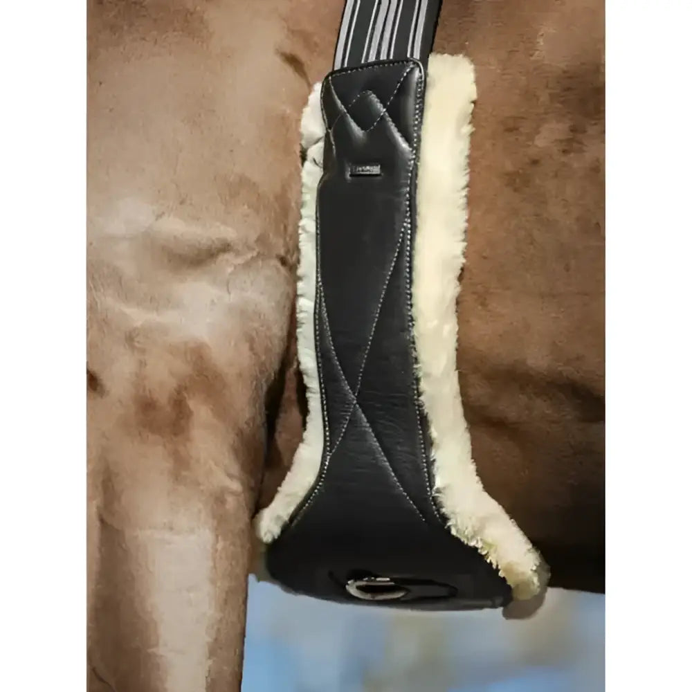Black leather horse saddle pad with cream shearling lining featuring lemieux arika simuwool contoured quilted design