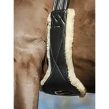 Black leather horse saddle pad with cream shearling lining featuring lemieux arika simuwool contoured quilted design