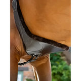 Black leather horse saddle pad with plush dark brown fleece lining paired with lemieux arika simuwool contoured long stud girth brown