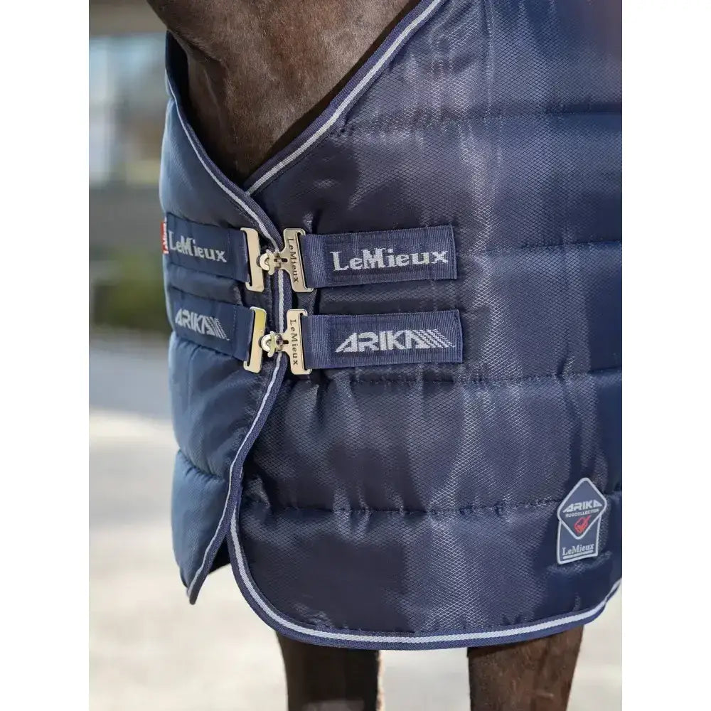 Navy blue quilted lemieux arika stable-tek 200g horse blanket with diamond ripstop outer silver buckles and white trim
