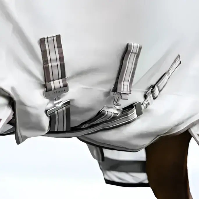 White lemieux arika sunstopper summer fly sheet with gray striped straps and metal buckles for sun protection