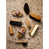 Wooden crafted lemieux artisan flick brush with natural bristles brown leather straps and special grooves by l’occitane