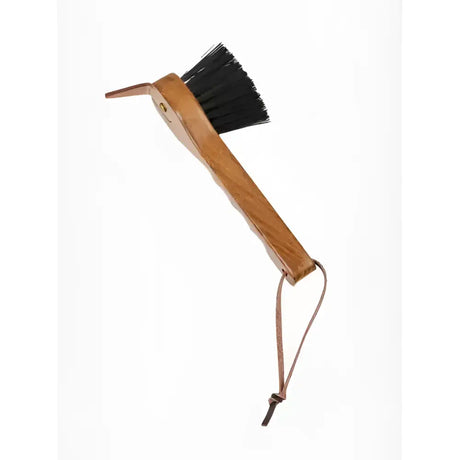 A lemieux artisan hoof pick with a wooden handle, black bristles, and leather strap for removing packed mud