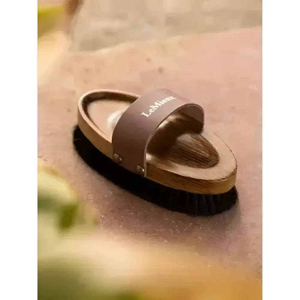 Brown leather strap lemieux artisan lambswool body brush with black bristles and natural lambskin handle