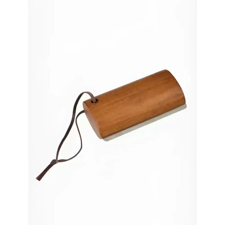 A smooth light brown wooden artisan shedding comb brown by lemieux artisan shedding with a black cord attached