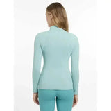 A light blue long sleeved fitted lemieux base layer aqua top with a high collar perfect for layering and warmth
