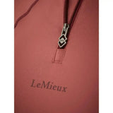 A coral lemieux base layer orchid pullover with a silver logo zipper pull designed for unrestricted comfort