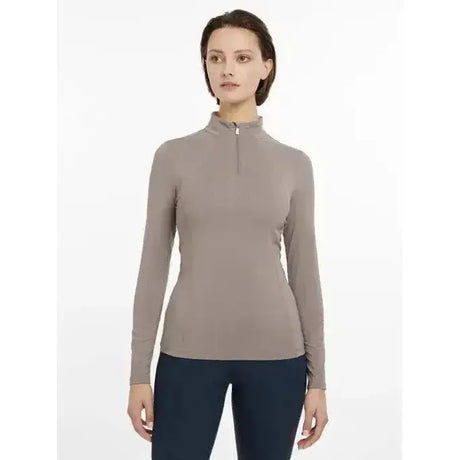 A sleek taupe lemieux base layer pecan with long sleeves, high collar, and front zipper for athletic wear
