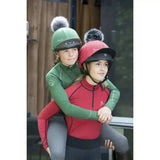 Green and red lemieux base layers chilli equestrian helmets with fluffy pom-poms perfect for rider base use