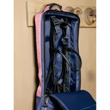 Lemieux bridle bag dusk blue with pink and navy panels and black straps hanging on a wooden hook