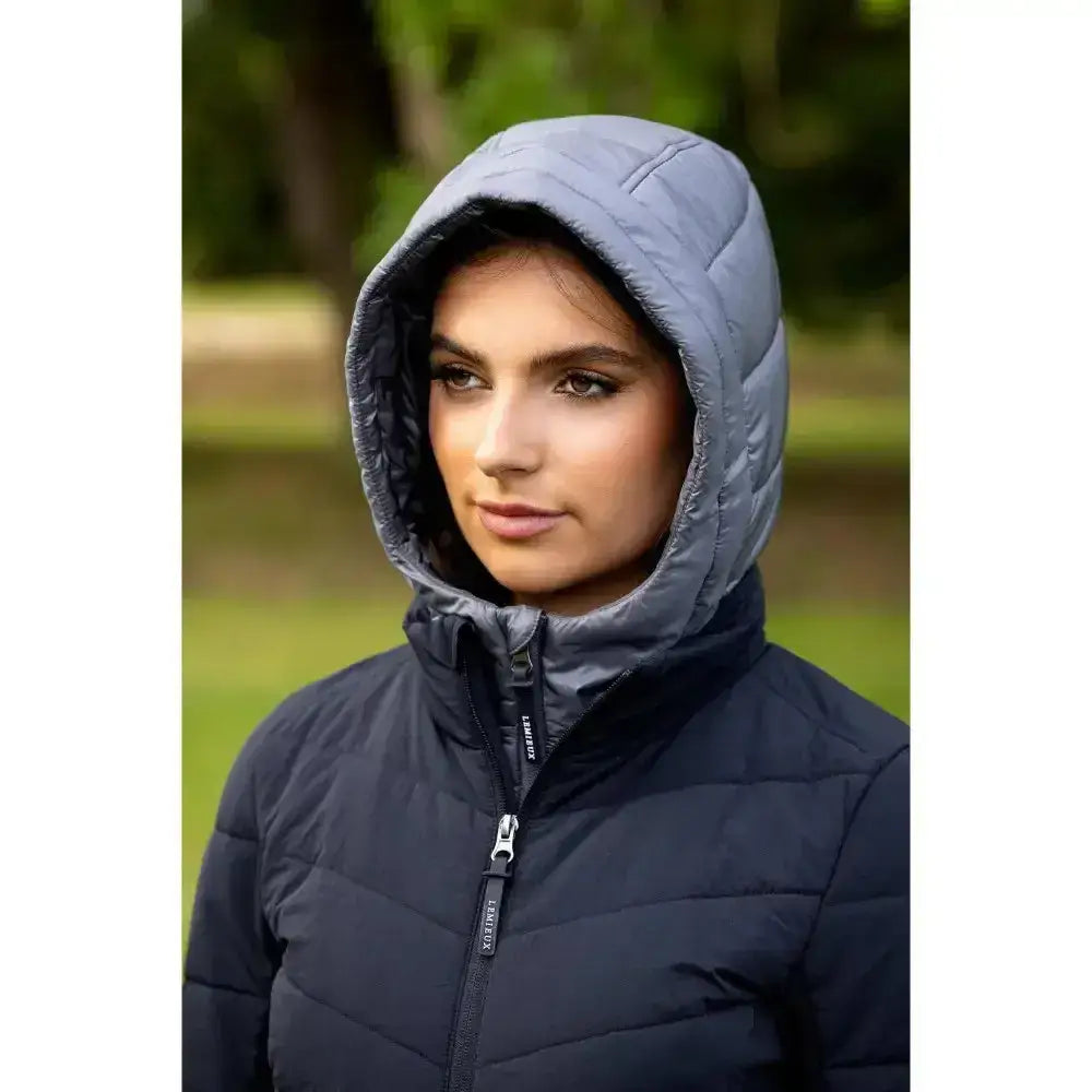 A dark navy quilted lemma brioney hybrid jacket with gray hood and visible stitching featuring sorel zipper pull