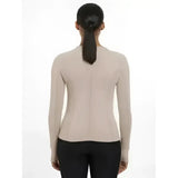 Beige lemieux britney seamless long sleeve top with a fitted design and central zipper on the back