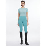 A sleek lemieux britney seamless short aqua top with matching teal high-waisted leggings and subtle pockets
