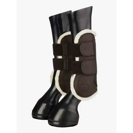 Black lemieux capella comfort tendon boot with white shearling lining and adjustable straps for cutting edge protection