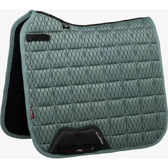 A quilted sage green lemieux carbon mesh dressage square with black trim and reinforced corners