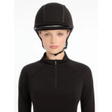 Equestrian wearing Lemieux Carmine Hat Silk Black riding helmet in stylish black attire