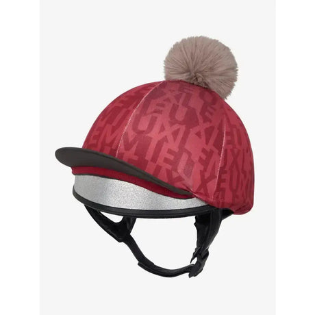 Red lemieux casey hat silk ember with beige faux fur pom pom and silver reflective band in repeating monogram pattern