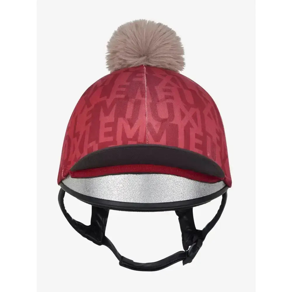 Red lemieux casey hat silk ember with repeating m pattern black trim silver band and beige faux fur pom-pom on top
