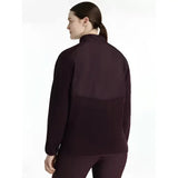 Dark purple lemieux clara hybrid fleece jacket with high collar and contrasting fabric panels for athletic use