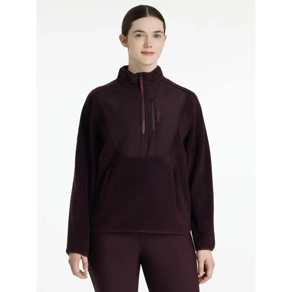 A dark maroon lemieux clara hybrid fleece pullover with long sleeves half-zip and subtle textured pattern