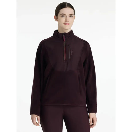 A dark maroon lemieux clara hybrid fleece pullover with long sleeves half-zip and subtle textured pattern