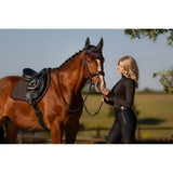 A sleek black horse with a glossy brown coat wears the lemieux classic fly hood cinder and full equestrian gear