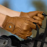 Lemieux classic leather riding gloves in simple brown leather with intricate stitching and a small metallic logo on wrist strap