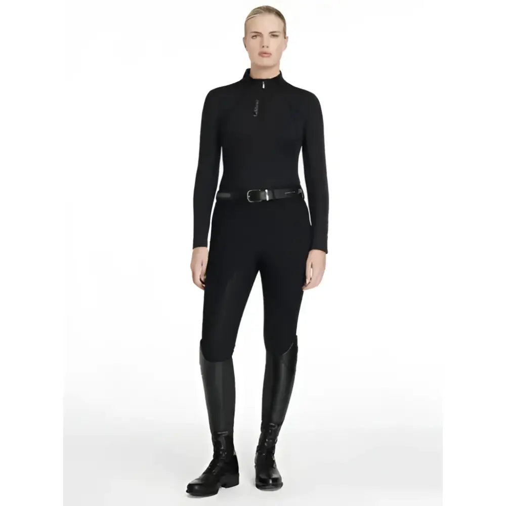 Black long sleeved lemieux classique base layer with high collar and zipper paired with matching black boots