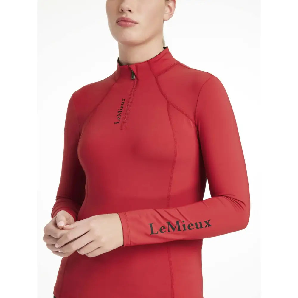 Red long-sleeved lemieux classique base layer chilli top with black branding on chest and sleeve perfect for performance