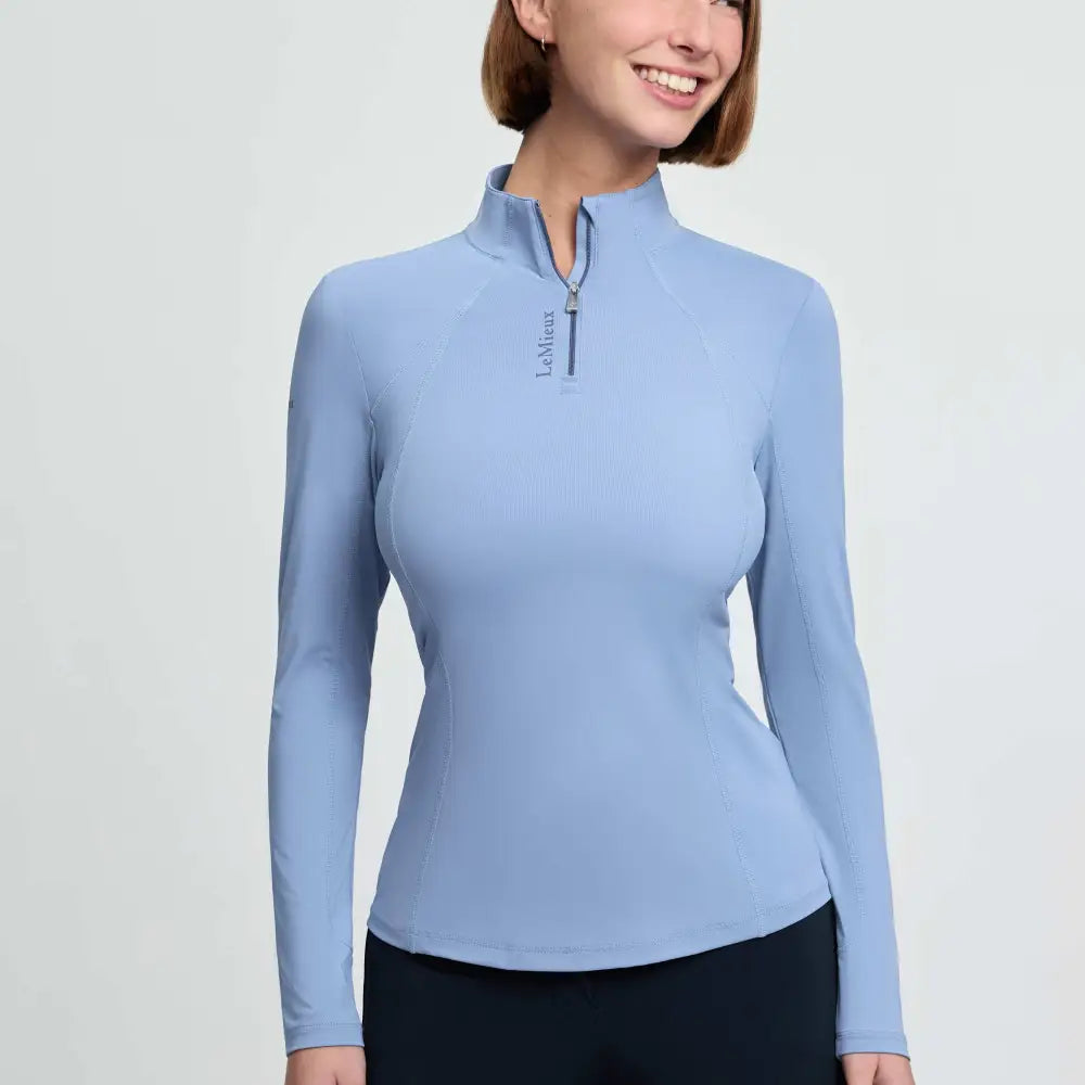 Light blue long-sleeved lemieux classique base layer with quarter-zip collar and vented underarms in powder blue