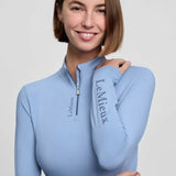 Light blue lemieux classique base layer with quarter-zip collar vented underarms and powder blue branding