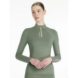 A sage green lemieux classique base long sleeve performance top with high collar zipper and embroidered logo