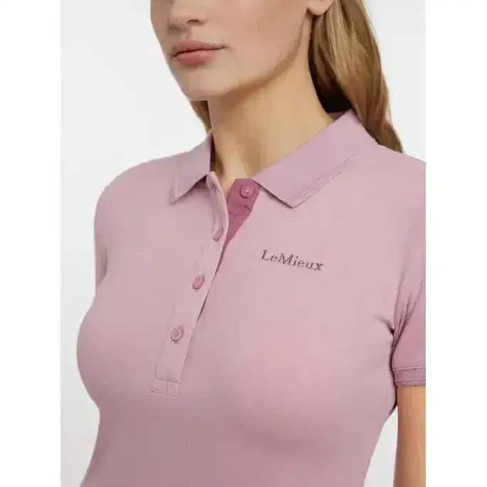 A soft pink lemieux classique polo shirt blossom with short sleeves, subtle textured weave, and embroidered logo on chest