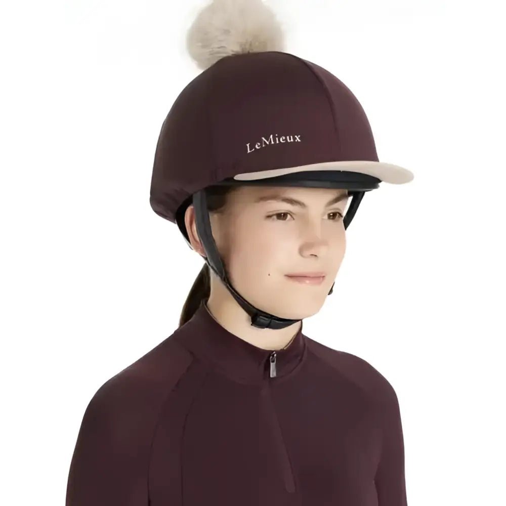 Maroon lemieux classique pom equestrian helmet with light brim and fluffy white pom in silk damson hat style