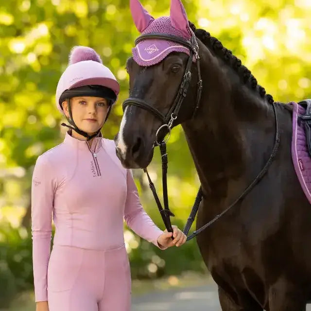 Pink lemieux classique pom equestrian helmet with silk fondant finish and fluffy faux fur pom on top