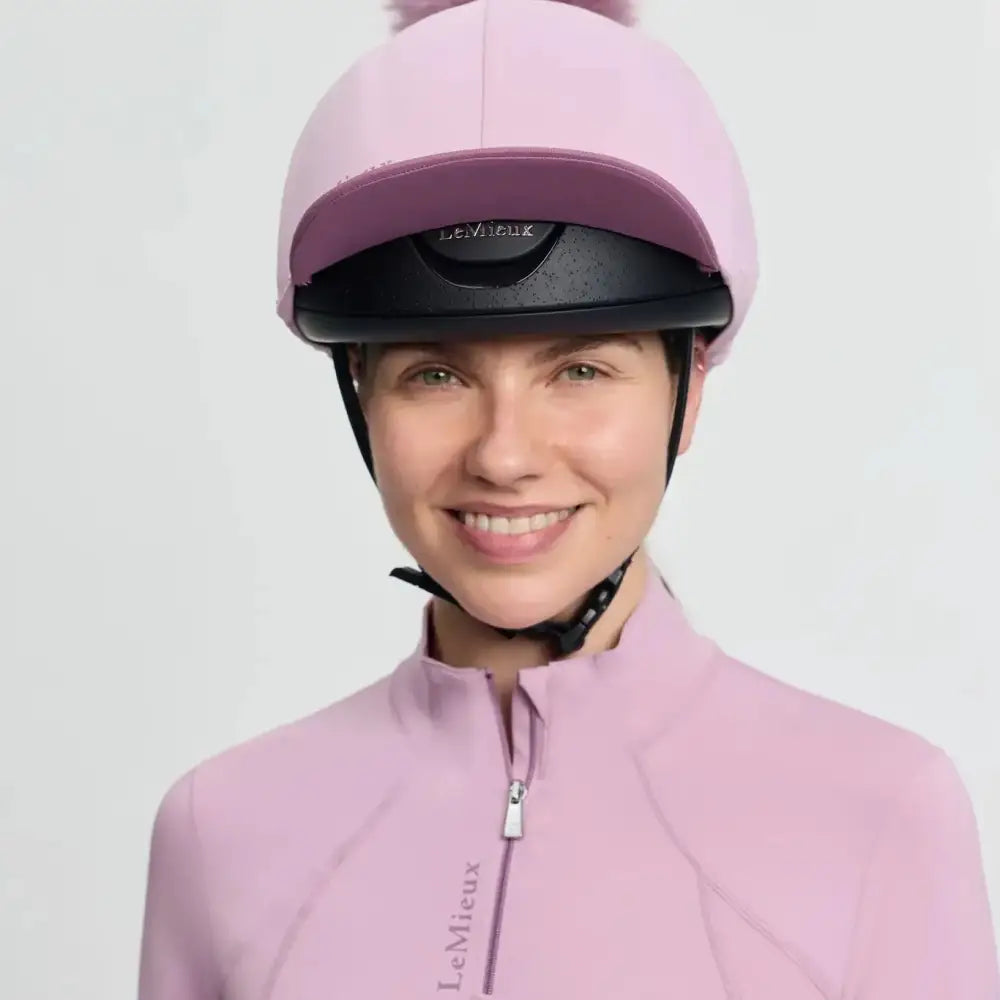 Soft pink lemieux classique pom equestrian helmet with silk fondant finish and matching faux fur pom on top