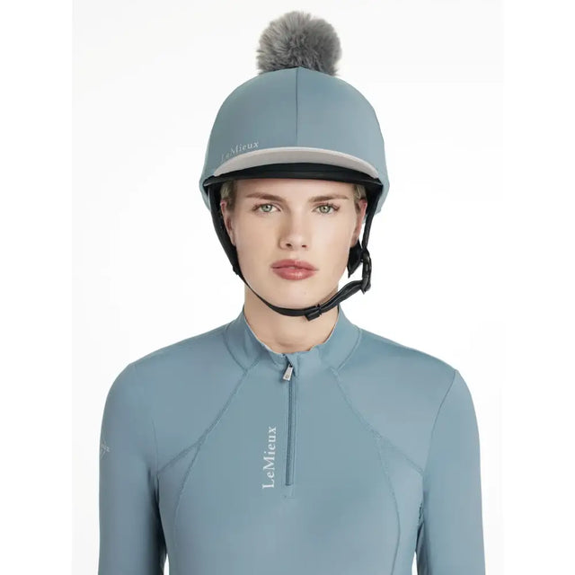 Light blue lemieux classique pom hat silk ice blue equestrian helmet with gray faux fur pom pom on top