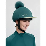 Teal lemieux classique equestrian helmet cover with faux fur pom in silk jungle pattern for stylish riding gear