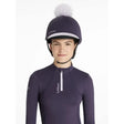 Navy blue lemieux classique pom equestrian helmet with white pom-pom and silk juniper logo on top