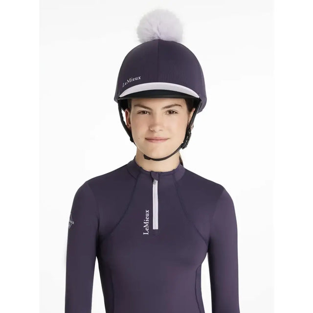 Navy blue lemieux classique pom equestrian helmet with white pom-pom and silk juniper logo on top
